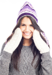 pretty brunette woman with a woolen Peruvian hat a sweater and gloves smiling and cheerful