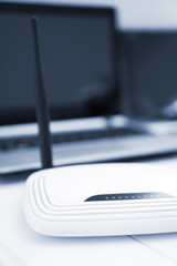 White wireless router standing on the table.