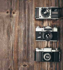 Vintage camera on wooden table and empty space for text