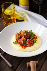 Meat meatballs in tomato sauce with mashed potatoes on a white plate, Swedish cuisine