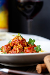Meat meatballs in tomato sauce with mashed potatoes on a white plate, Swedish cuisine