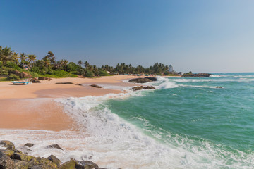 Tropical beach with coconut palms. Tropical vacation  in Sri Lanka. Hikkaduwa. Ambalangoda