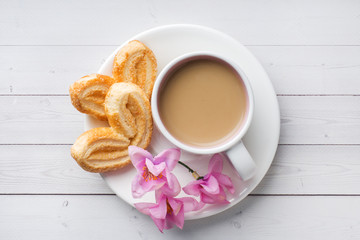 Valentine's day Breakfast concept. Cup of coffee and a cookies hearts on a white table. copy space, flat lay.