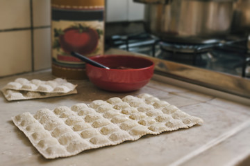 Traditional raw ravioli, on the marble of the kitchen,