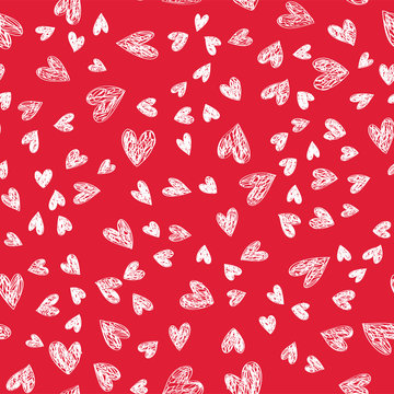 Holiday doodle Lovely Valentines Day background seamless pattern with cute hand drawn white hearts on red background. Vector illustration.