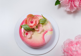 pink round cake with flowers on the white background