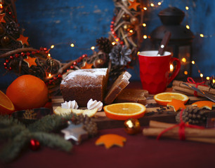 Christmas and New year background with Pie and a mug of coffee on the cutting board,oranges,Tree decorations ,lantern,  lights/top view/flat lay