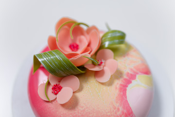 pink round cake with flowers on the white background