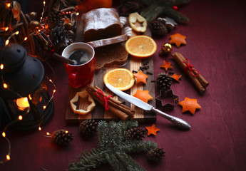 Obraz na płótnie Canvas Christmas and New year background with Pie and a mug of coffee on the cutting board,oranges,Tree decorations ,lantern, lights/top view/flat lay