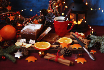 Christmas and New year background with Pie and a mug of coffee on the cutting board,oranges,Tree decorations ,lantern,  lights/top view/flat lay