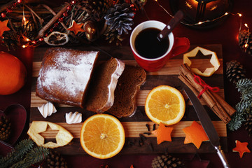 Christmas and New year background with Pie and a mug of coffee on the cutting board,oranges,Tree decorations ,lantern,  lights/top view/flat lay
