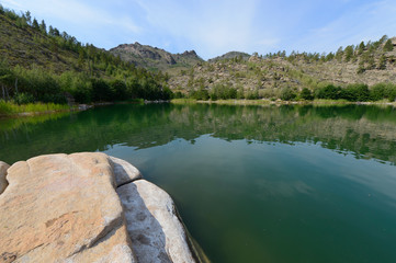Summer landscape with lake and rocks