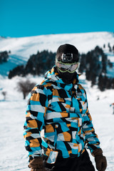 Fototapeta na wymiar snowboarder close up with action camera on his head teal and orange