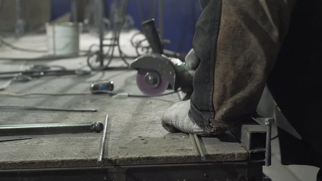 Close-up - A Blacksmith In Protective Gloves Lays Two Iron Rods