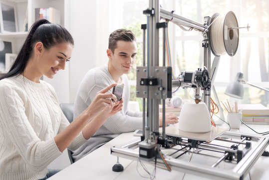 Academic students using a 3D printer in the lab