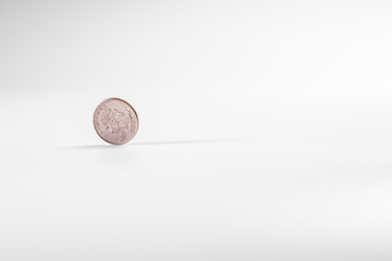Dollar coin rotating on white background, concept of American economy.