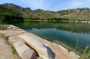 Summer landscape with lake and rocks