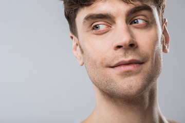 Obraz premium portrait of handsome young man looking away isolated on grey
