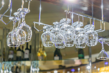 hanging glassware. Empty clean glass for vine and champaпgne at the bar. Selective focus