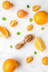 Fresh orange fruits with mint on table background top view pattern