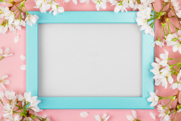 Turquoise springtime frame with blank space and cherry blossom