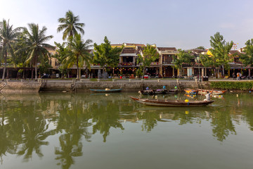 Fototapeta na wymiar Waterfront view of Thu Bon River, at Hoi An ancient town historic district, UNESCO world heritage site. Its a popular travel destination, Vietnam.