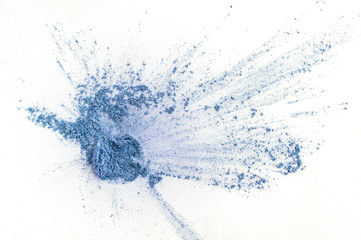 Loose blue eye shadow powder, isolated on white background.