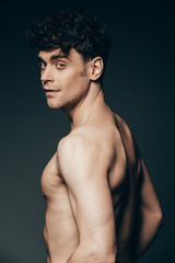 Fototapeta premium handsome brunette macho isolated on dark grey