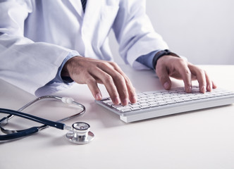 Doctor typing on keyboard. Medical technology concept