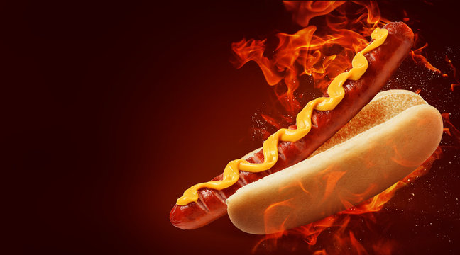 hot dog with big sausage and mustard on fire background