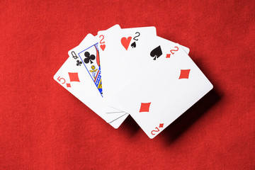 top view of red poker table and playing cards combination with different suits