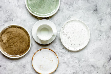 ceramic tableware top view on stone background mock up