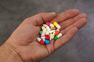 Handful Various colorful pills .
