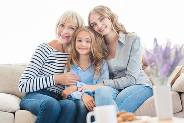 Grandmother with daughter and granddaughter on sofa