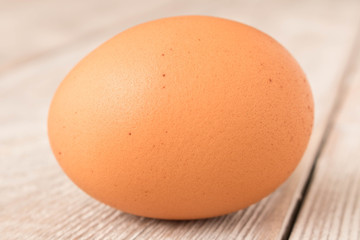 Chicken egg on a wooden table. Close up.