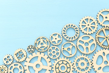 photo of working system of cogwheels,concept of teamwork, wooden textured background