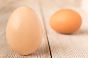 Chicken eggs on a wooden table. Selective focus.