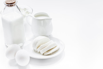 monochrome concept with dairy products on white table mock up
