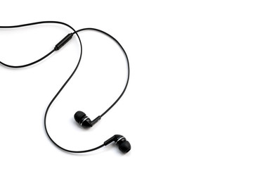 Earphones headset. In-ear headphones. Vacuum wired black headphones for listening to music and sound on portable devices: music player, smartphone, laptop on a white background. Ear plugs.