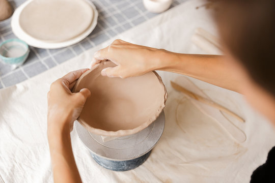 Close up of a woman making ceramic and pottery