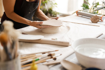 Fototapeta na wymiar Close up of a woman making ceramic and pottery
