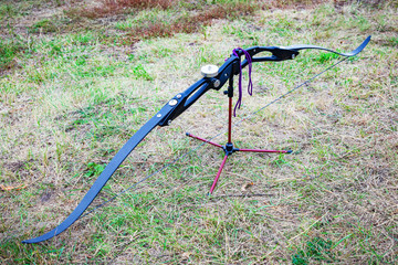 Closeup of composite bow and arrows. Background of grass.