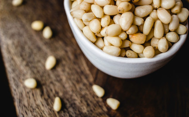 Pine Nuts on Dark Wooden Table. Closeup, horizontal. Raw Healthy Food