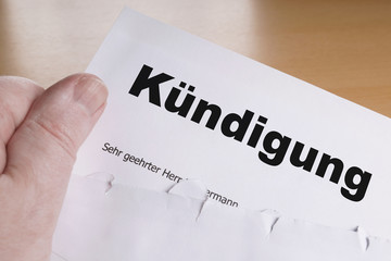 Kuendigung male hand holding german termination letter