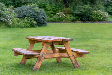 Picnic table with benches on green grass