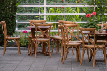Wooden table and armchair standing outside cafe