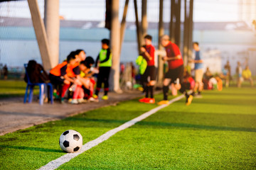 soccer ball at touchlines on artificial turf with blurry of soccer players