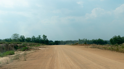 Fototapeta premium Traveling new soil road with nature of grass and tree at Ang Kep Nam Dok Krai,Mae Nam Khu, Pluak Daeng District, Rayong Thailand.