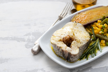boiled fish with vegetables on white dish