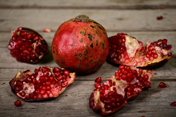 Juicy pomegranate on wooden background
